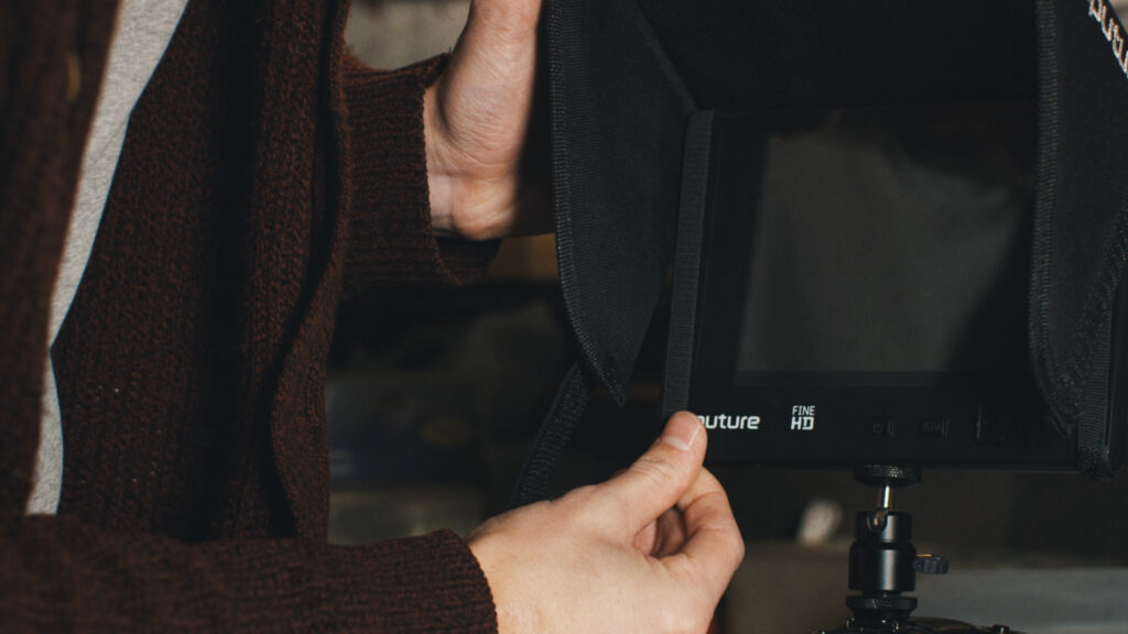 Still of a person adjusting a sun hood. 