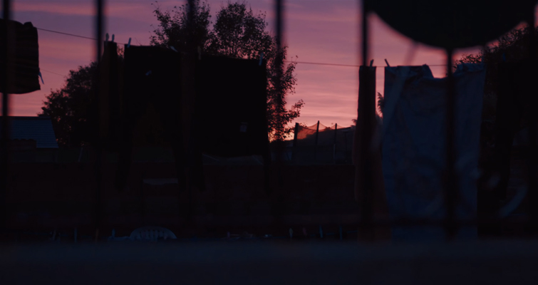 Shot of neighbours laundry under a pink sky. 
