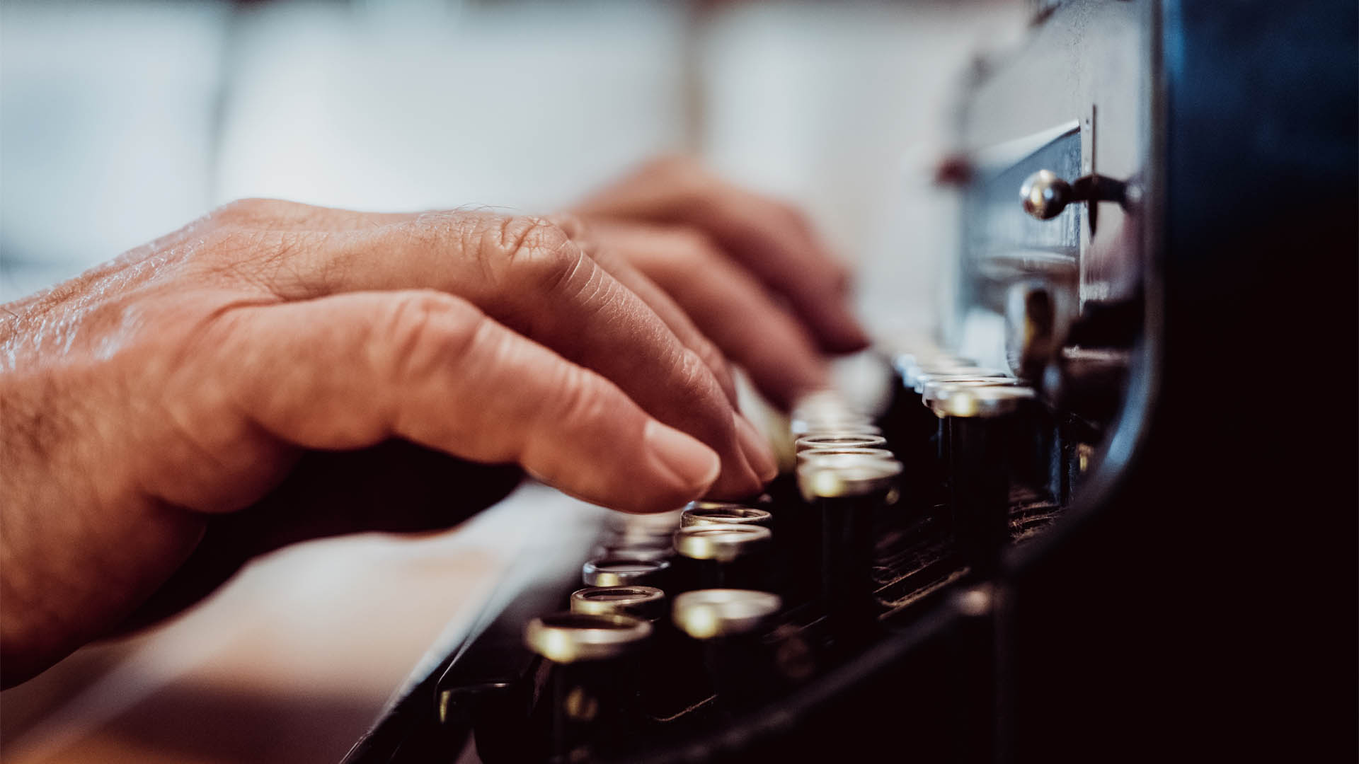 A man typing on a typewriter.