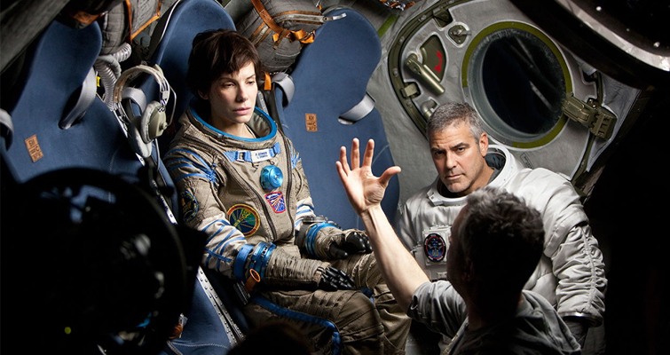 Sandra Bullock, George Clooney and director Alfonso Cuarón on the set of Gravity. 