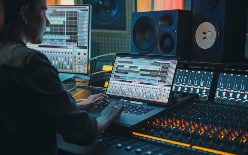 Woman on a laptop in a professional studio.