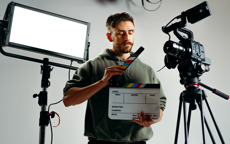 Camera man holding clapperboard - Gifts for Filmmakers
