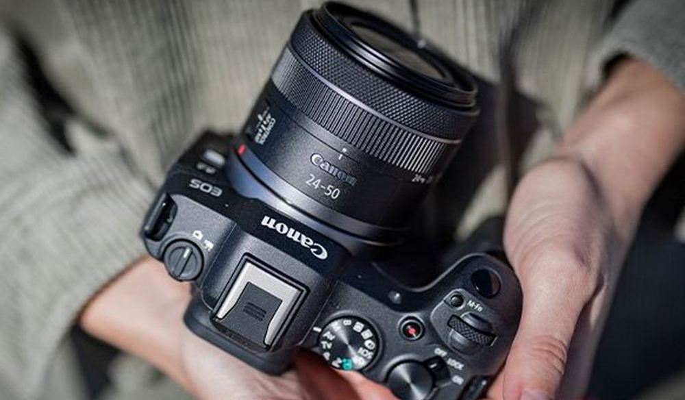 Canon EOS R8 in someone's hands.