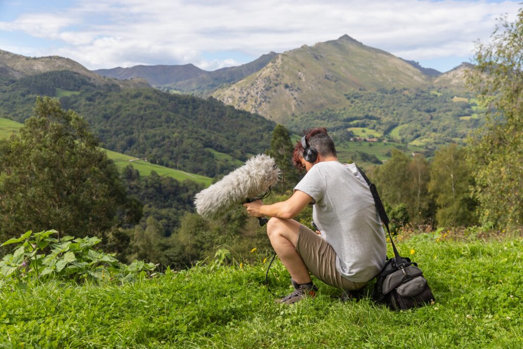 A field recordist capturing field recordings in the mountains. 