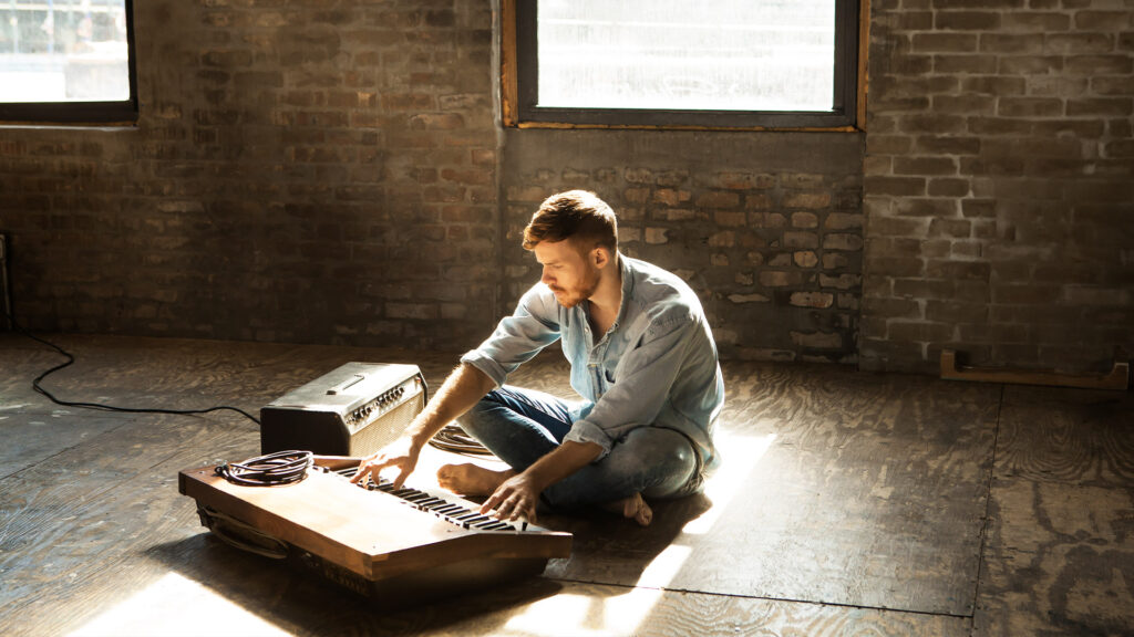 A man creating music on an analogue synth